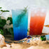 Clear Karat 32oz PP Plastic Cold Cup with one red and one blue drink