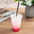 Clear Karat 95mm PS Plastic Flat Lids on clear matching cup with pink drink with black straw