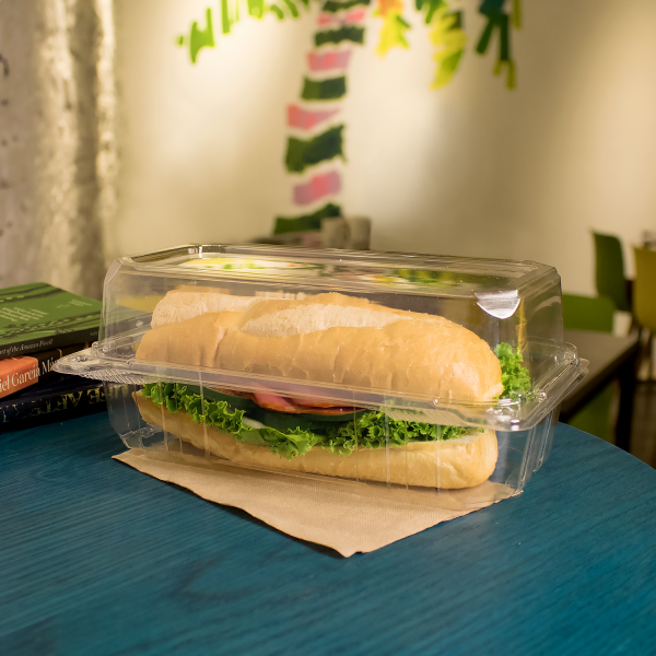 Clear Karat 9" x 5" PET Plastic Hinged Containers with a sub sandwich