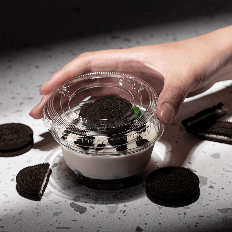 Karat 92mm PET Plastic Flat Lids with no holes beside dessert cup with cookie and pudding inside