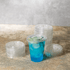 Karat PET Clear Flat Lid for 7oz PET Cup on matching cup filled with blue drink