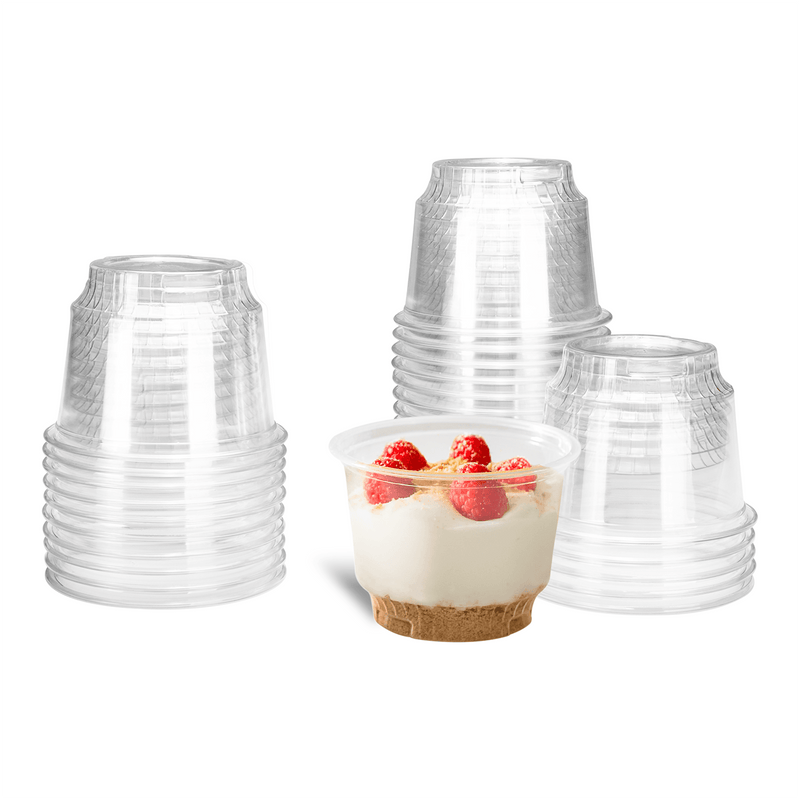 Clear Karat 8oz PET Plastic Dessert Cups stacked and one with dessert