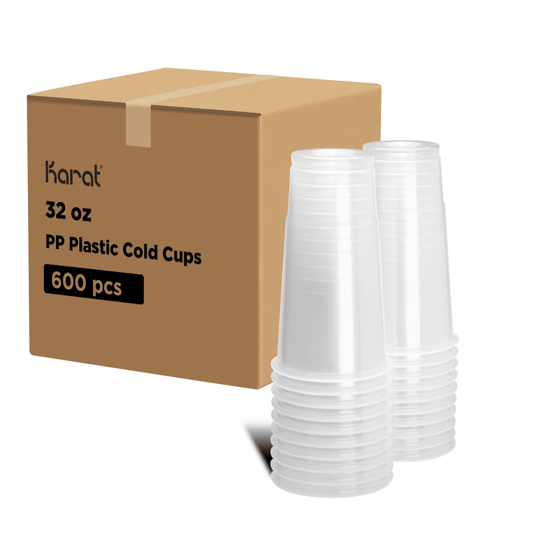 Clear Karat 32oz PP Plastic Cold Cups stacked next to packaging