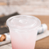 Clear Karat 95mm PS Plastic Flat Lids on clear matching cup with pink drink