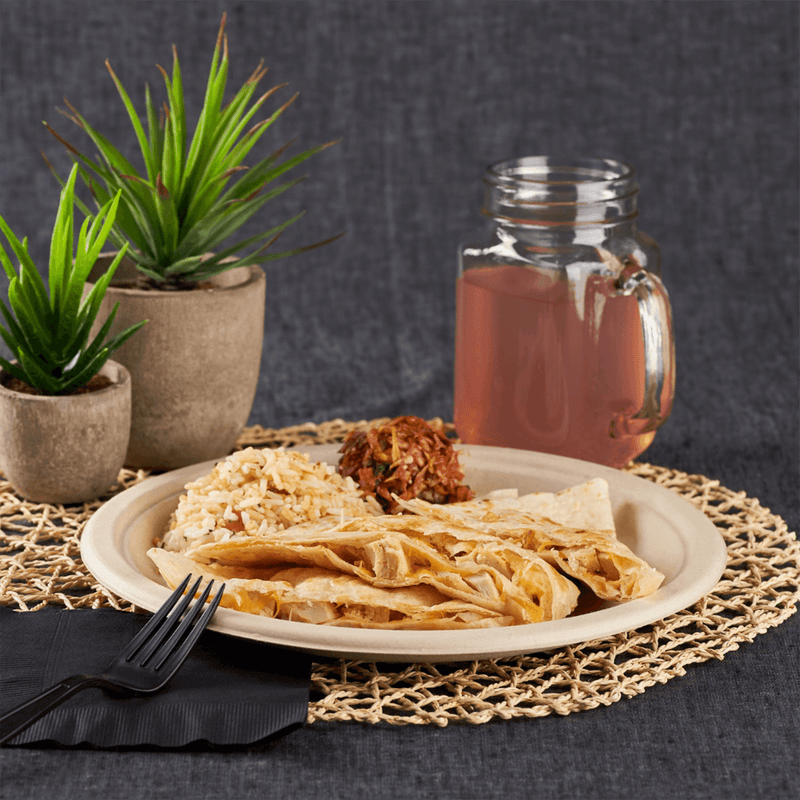 Natural Karat Earth 10'' PFAS Free Compostable Bagasse Round Plates with quesadillas, rice, and utensils