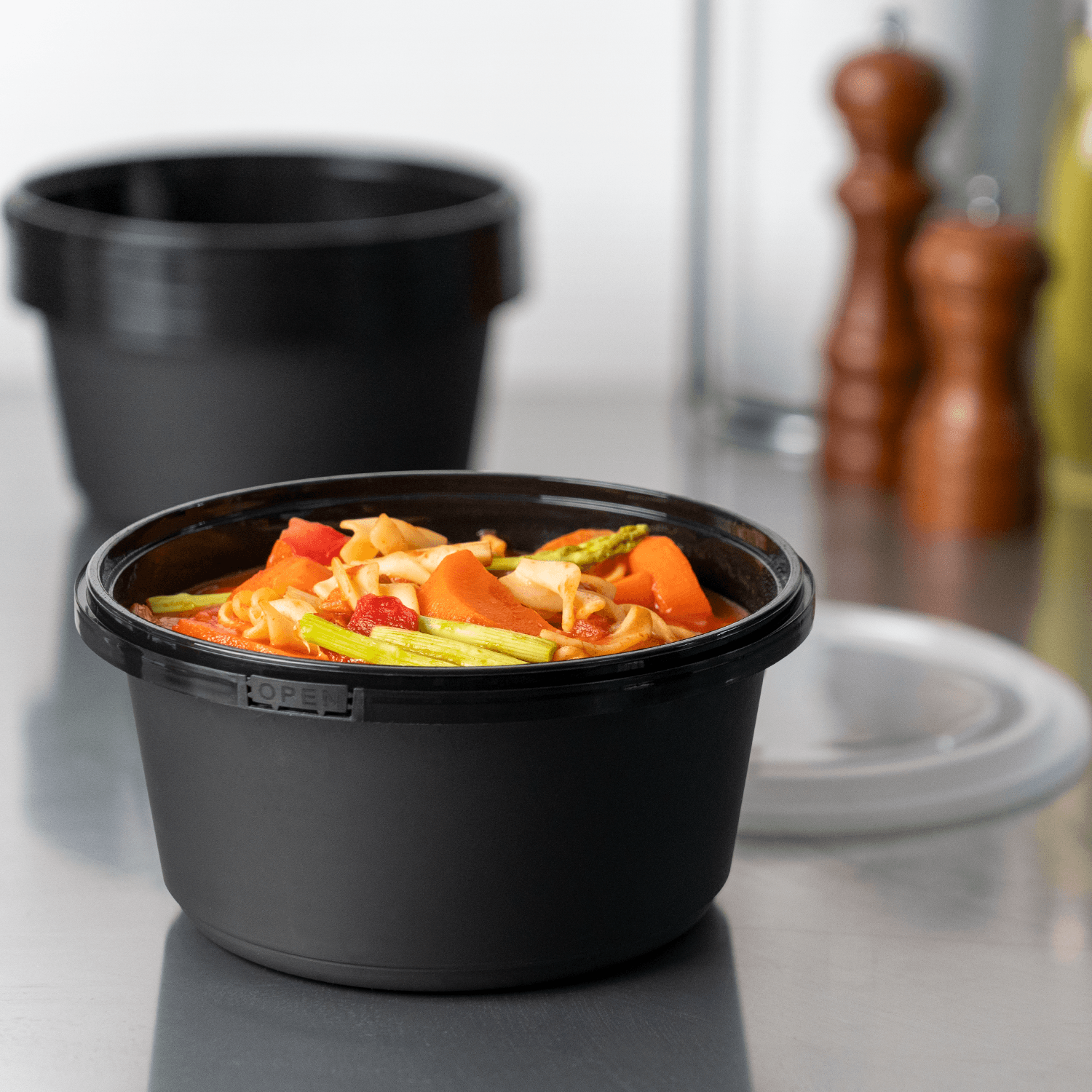 Karat 44oz PP Tamper Resistant Injection Molded Microwaveable Black Food Container w/Clear lid - 150 pcs