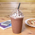 Clear Karat 98mm PET Plastic Dome Lids on matching cup with chocolate frozen drink and black straw