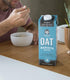oat milk being used in cereal