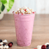 Clear Karat 20oz PET Plastic Cold Cup with pink smoothie and toppings