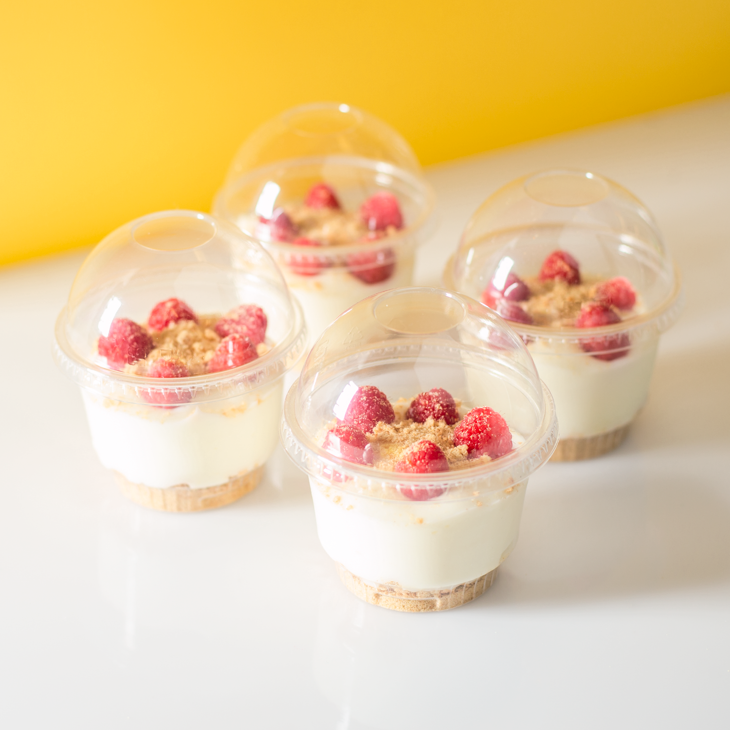 Clear Karat 8oz PET Plastic Dessert Cup with raspberry cheesecake and dome lid