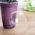 Clear Karat 95mm PP Plastic Dome Lids on matching clear cup with blueberry smoothie