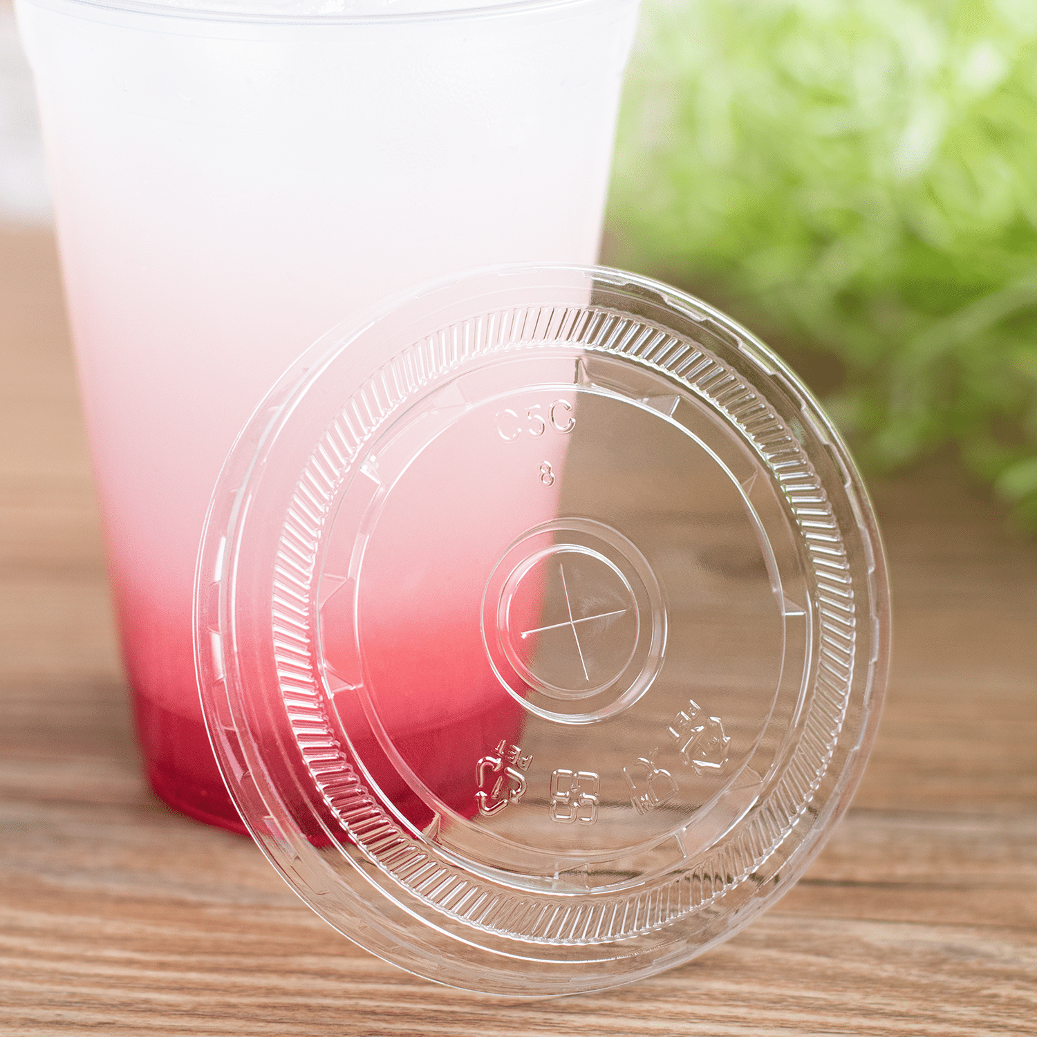 Clear Karat 95mm PS Plastic Flat Lids on clear matching cup with pink drink