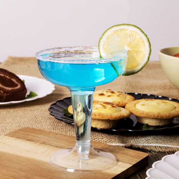 Karat 4oz PS Plastic Champagne Coupe with blue drink and lime
