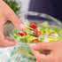 Clear Karat 24 oz PET Plastic Tamper Resistant Hinged Salad Bowl with Dome Lid filled with salad