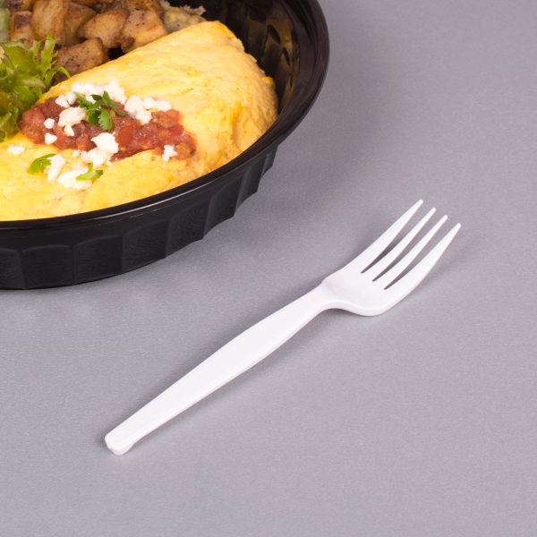 White Karat PS Plastic Medium-Heavy Weight Fork next to omelet